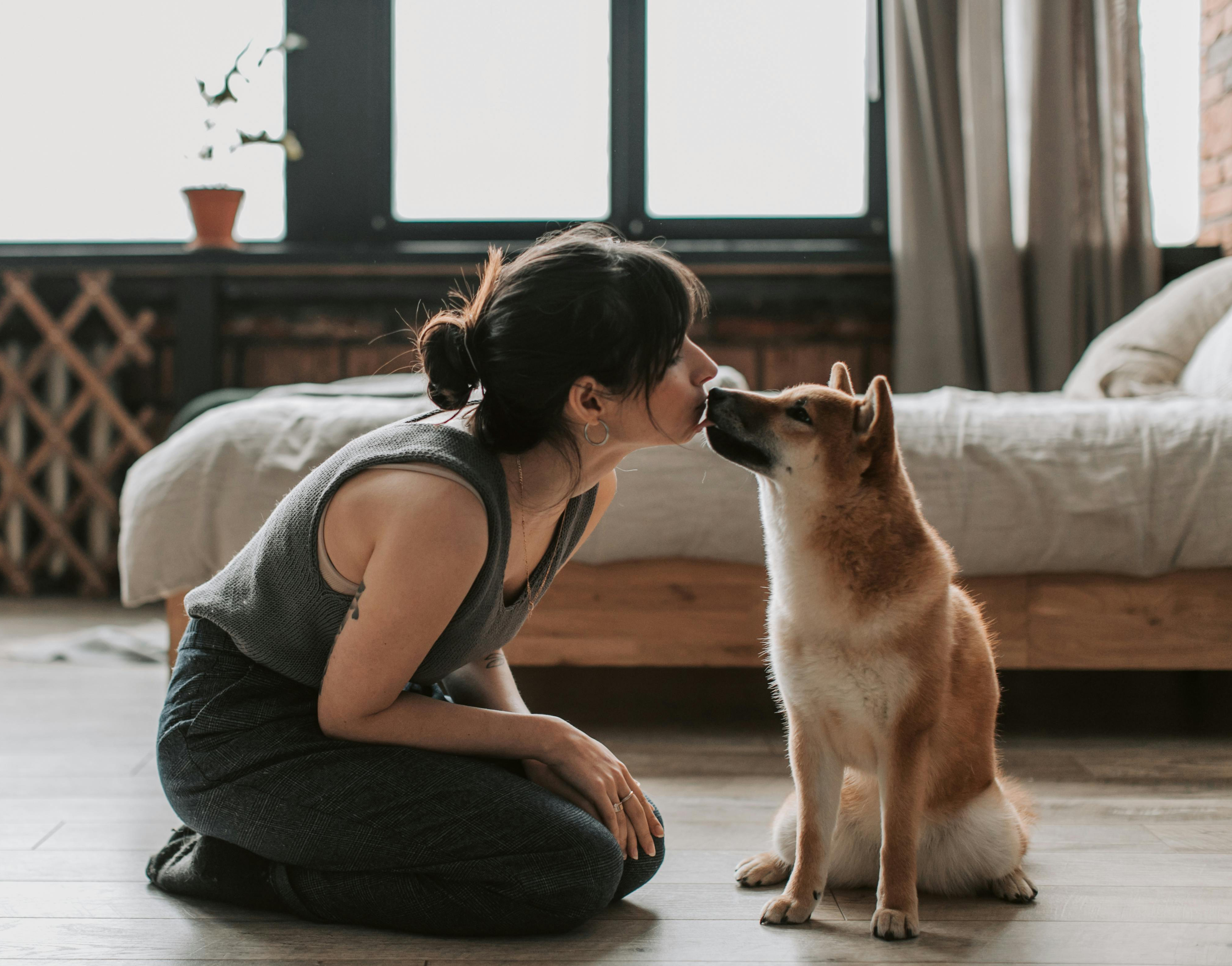 owner kissing her dog